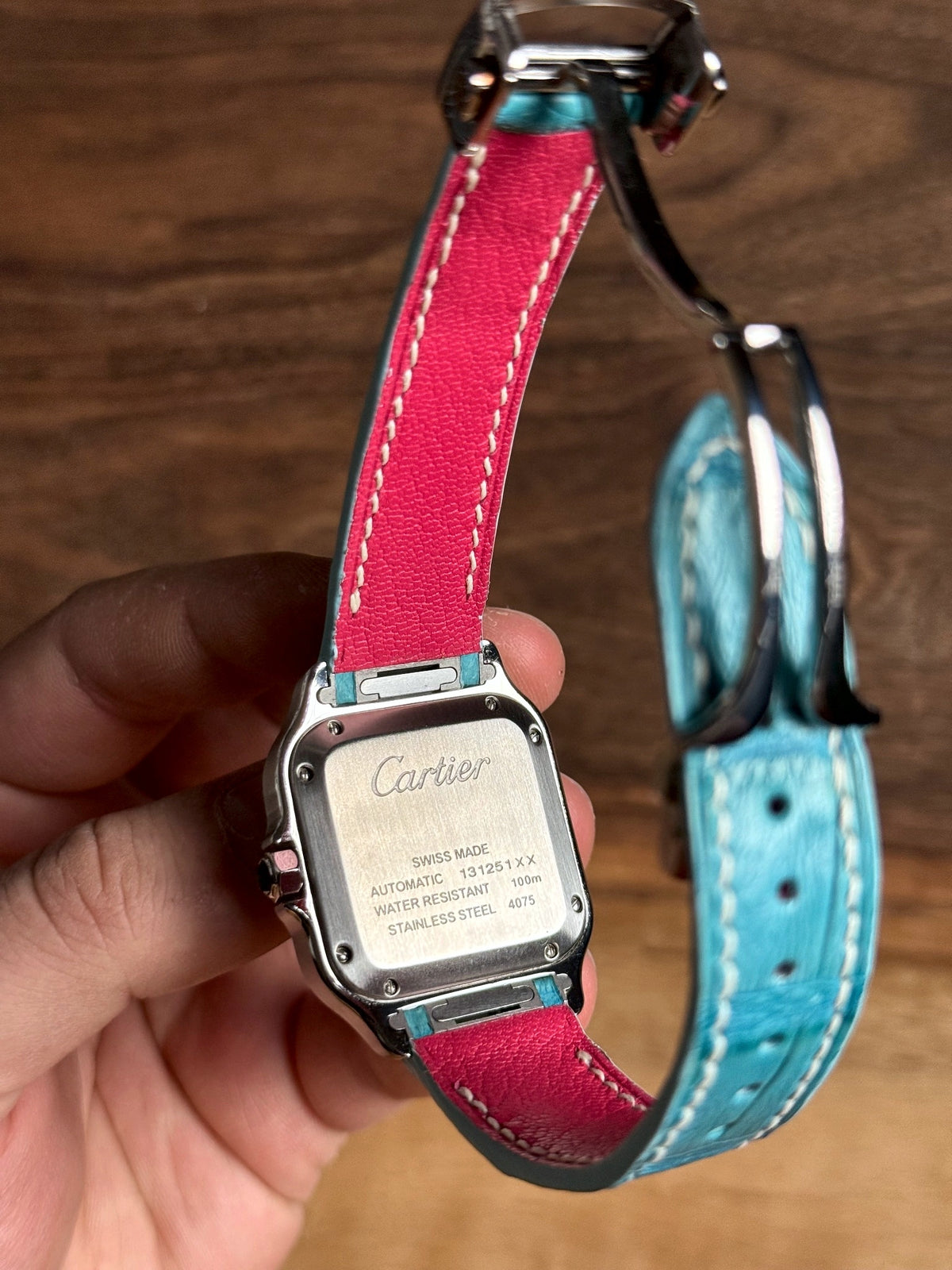 Turquoise alligator strap with a pink lining on a Cartier Santos