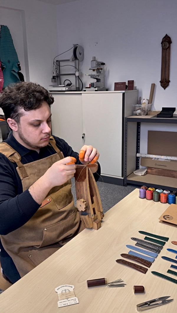 Saddle stitching a strap by hand at the workbench