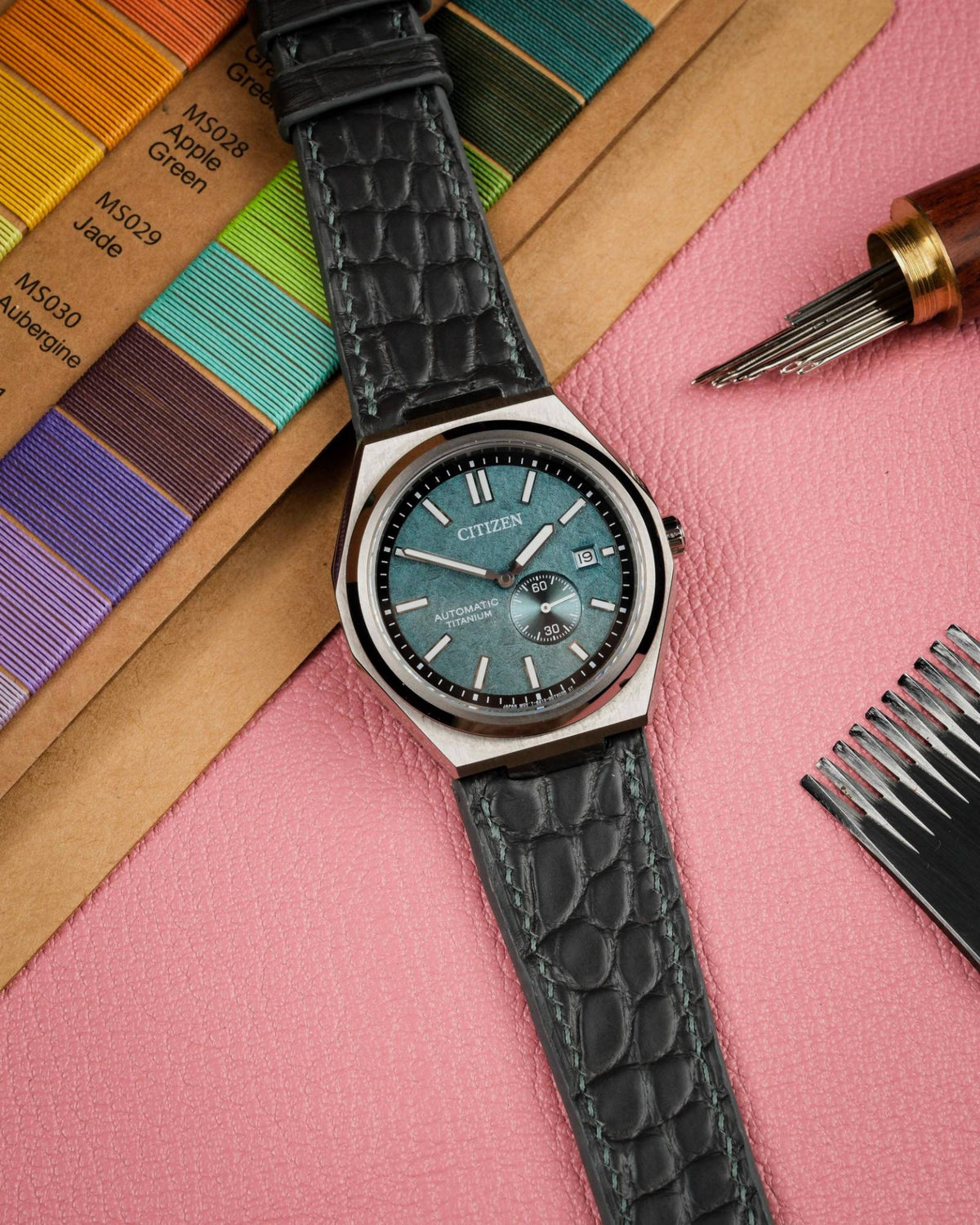 Hand-stitched grey matte alligator strap on a Citizen Zenshin with needles and pricking iron – Atelier Taha